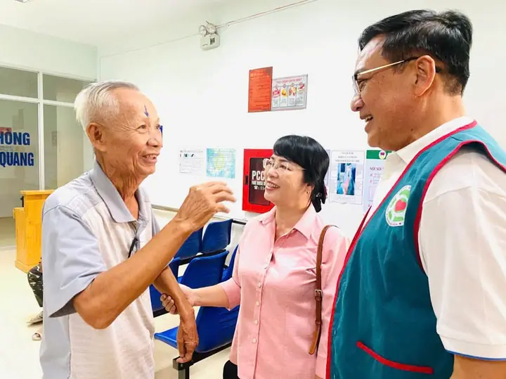 Hội viên thăm hỏi bệnh nhân cao tuổi trước ca mổ mắt